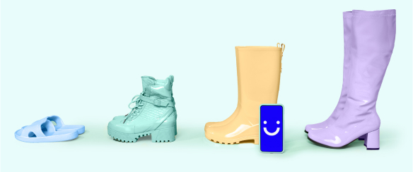 Different sized shoes and boots with a Visible phone next to them