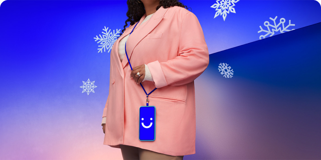 Woman with visible phone wearing a pink coat surrounded by snowflakes