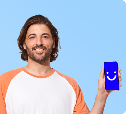 man smiling while holding up a Visible phone