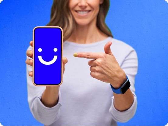 smiling woman pointing to visible phone