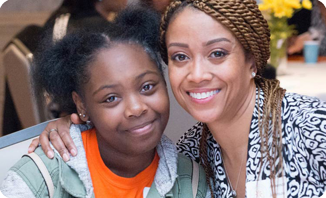 smiling woman and young girl